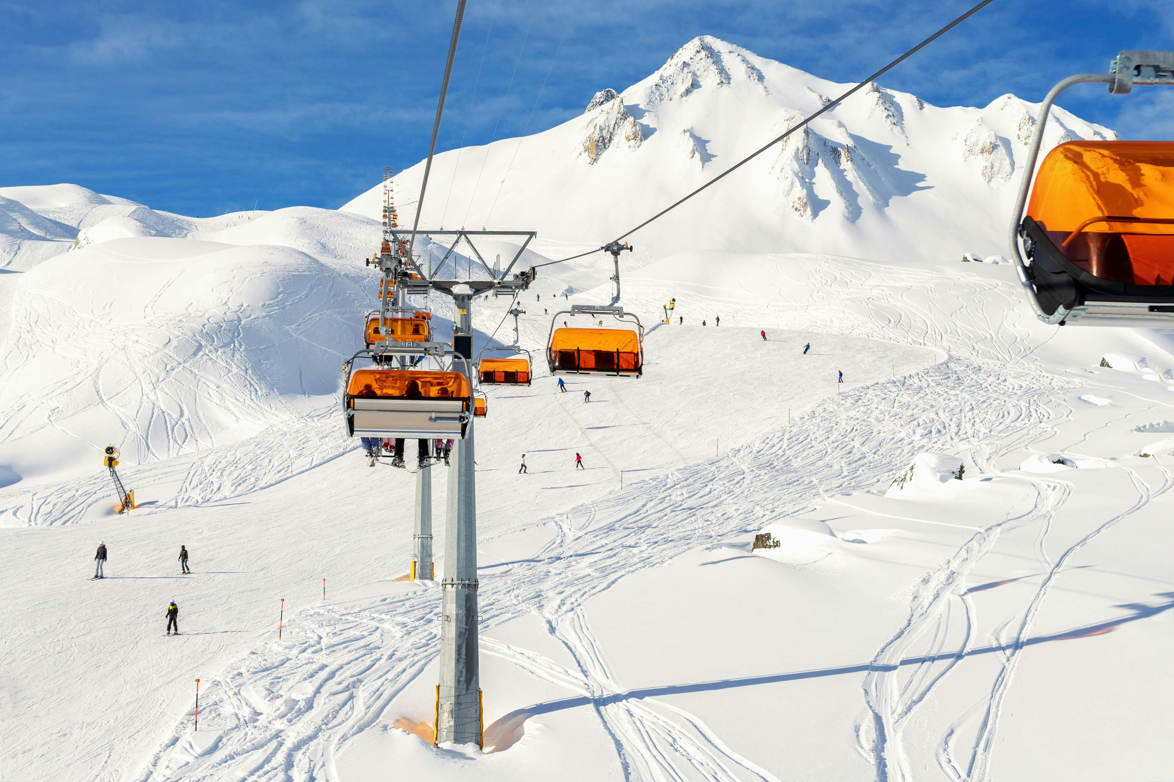 ski-school-ischgl_SEM-Resort-Hero A ski lift and the snowy slopes of Silvretta Arena Ischgl, where a local ski school offers their ski lessons.