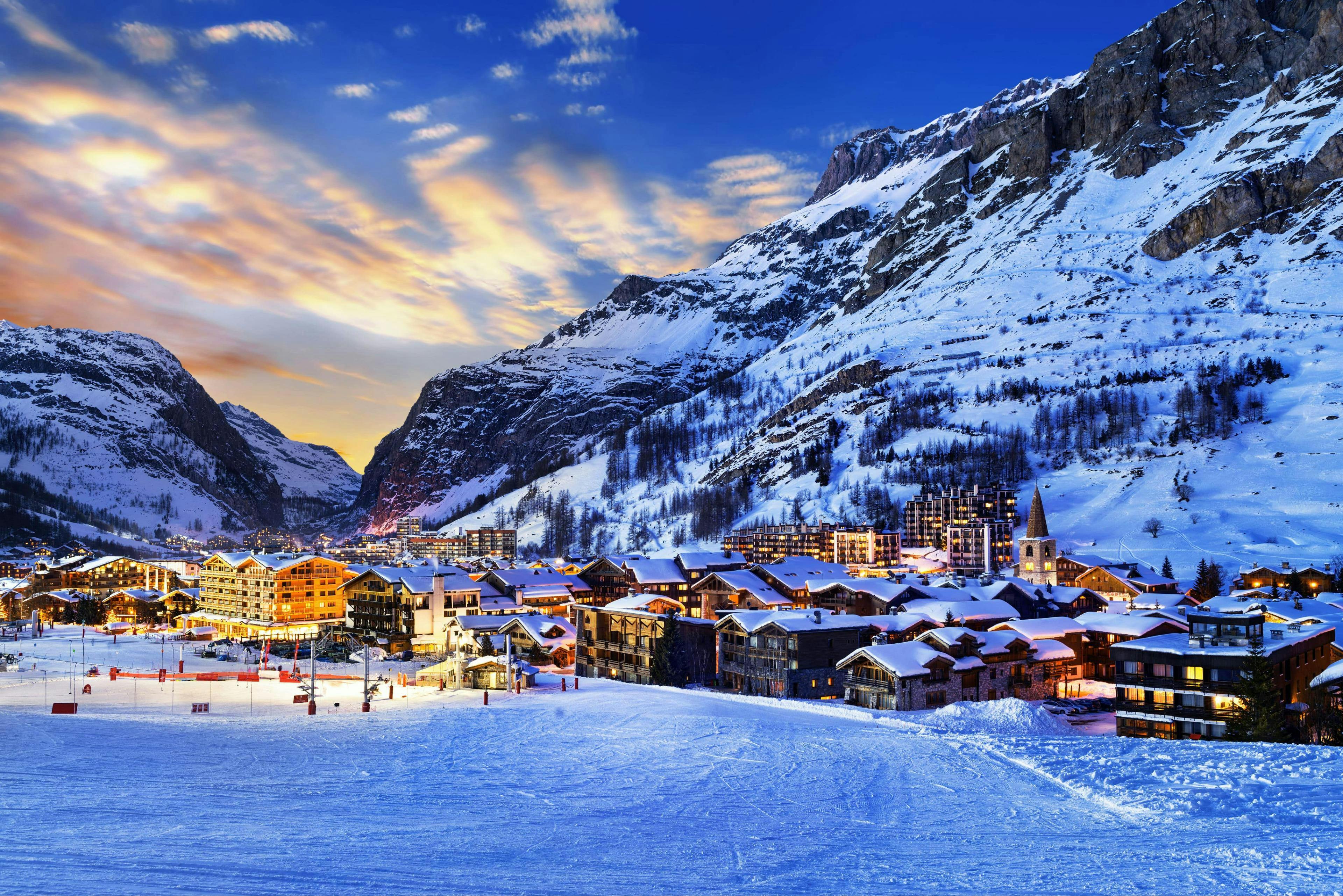A view of the wonderful French ski resort Val d'Isère surrounded by snow at sunset.
